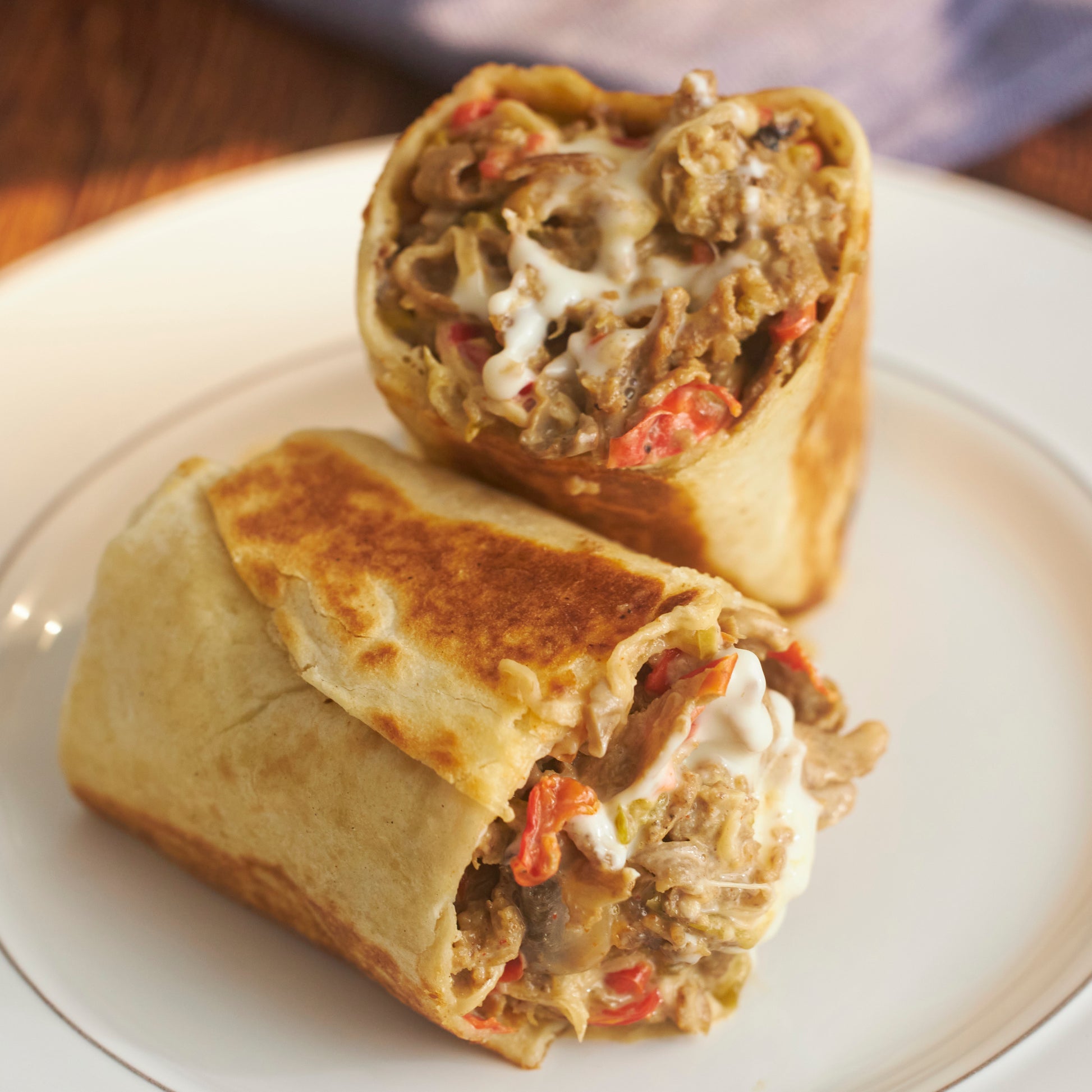 Picture of a cheesesteak burrito on a plate